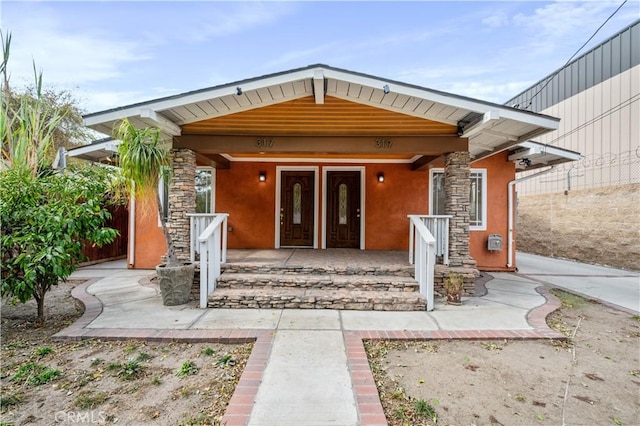 view of exterior entry with a porch