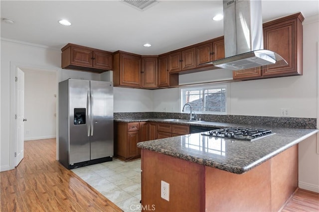 kitchen featuring sink, stainless steel appliances, island range hood, ornamental molding, and kitchen peninsula