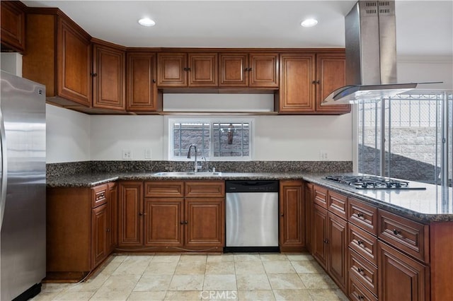 kitchen with sink, stainless steel appliances, dark stone counters, and island exhaust hood