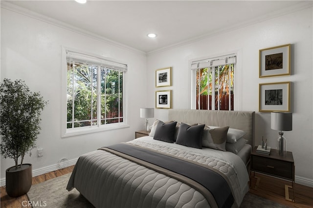 bedroom featuring multiple windows, wood-type flooring, and ornamental molding