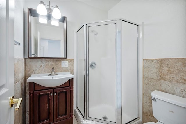 bathroom featuring vanity, tile walls, and walk in shower