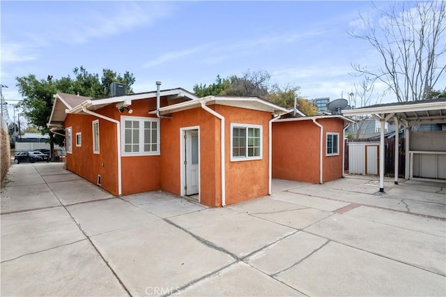 rear view of house featuring a patio and central AC unit