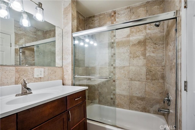 bathroom with vanity and combined bath / shower with glass door