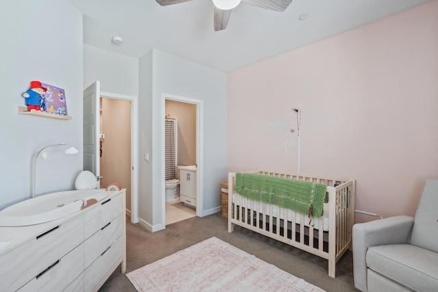 carpeted bedroom with a nursery area, ceiling fan, and connected bathroom