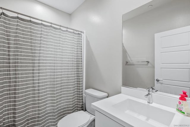 bathroom with vanity, toilet, and a shower with shower curtain