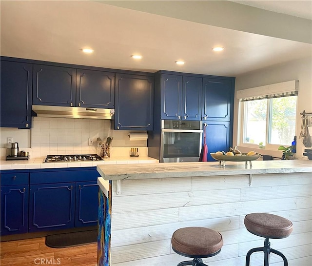 kitchen featuring blue cabinets and a breakfast bar