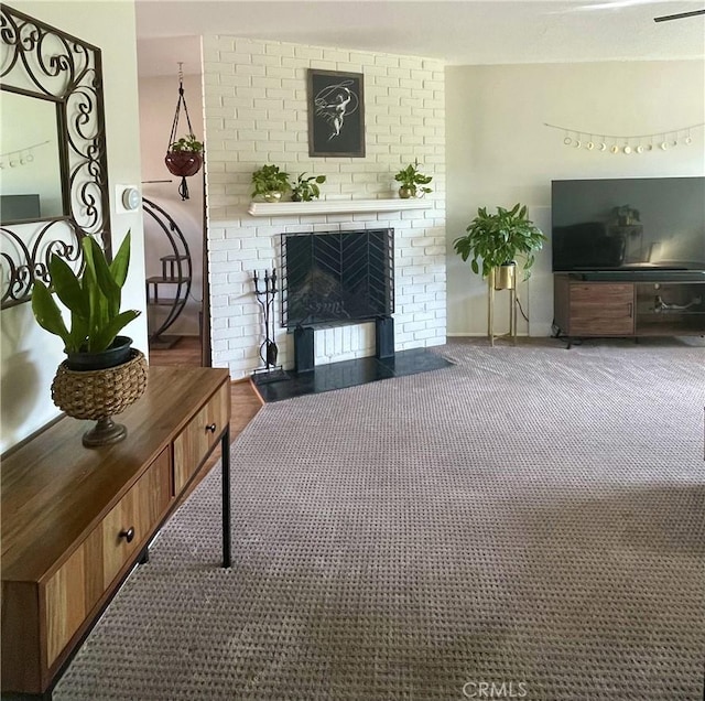 living room featuring carpet flooring and a fireplace