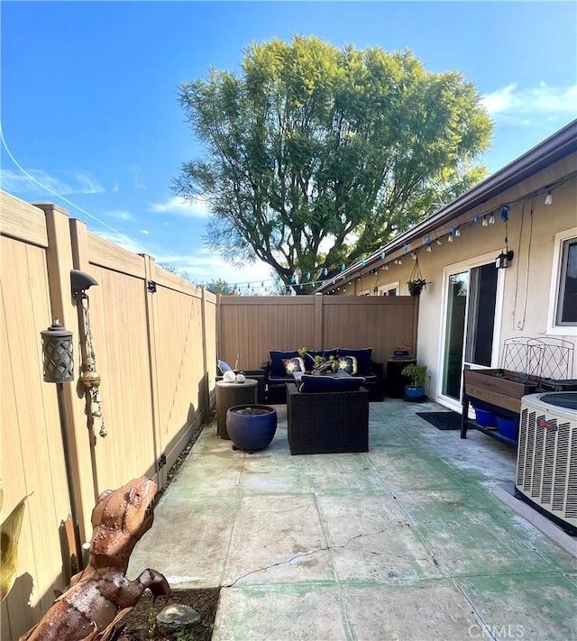 view of patio / terrace with an outdoor living space and central AC