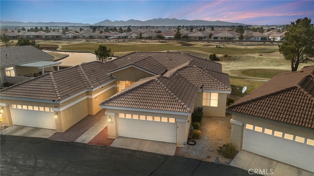 view of front facade with a garage and a mountain view