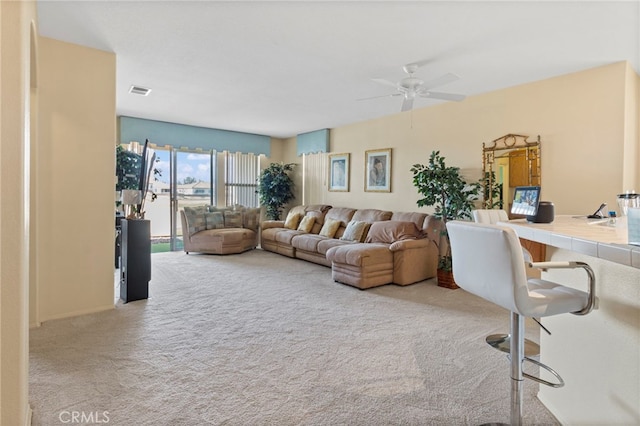 carpeted living room featuring ceiling fan