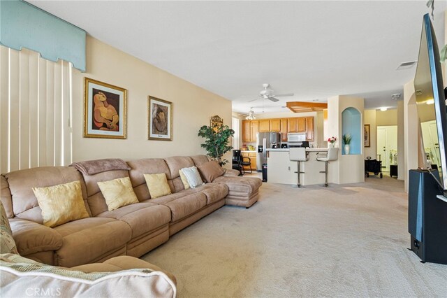 living room featuring ceiling fan and light carpet