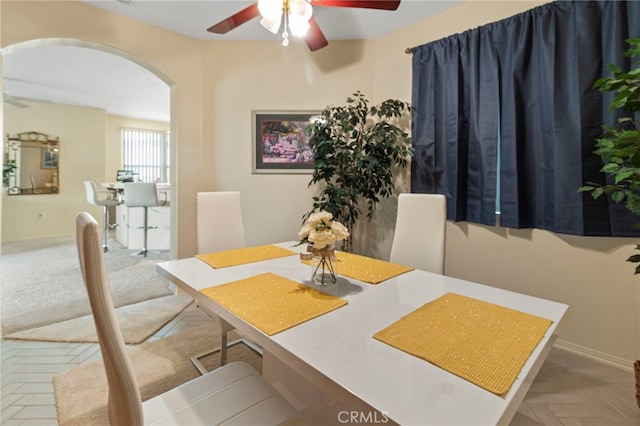 dining area featuring parquet flooring and ceiling fan