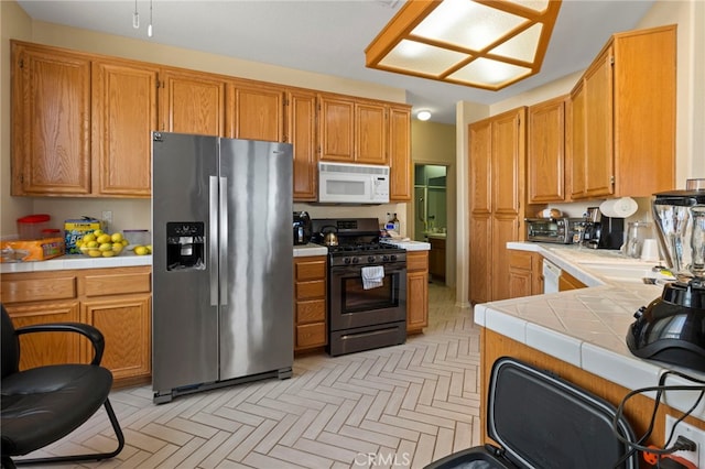 kitchen featuring tile counters and appliances with stainless steel finishes