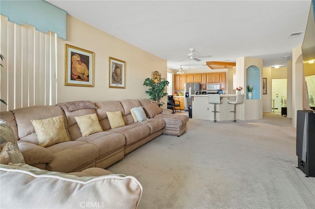 living room with ceiling fan and light carpet