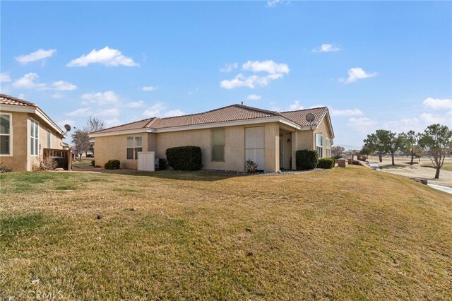 view of home's exterior with a lawn