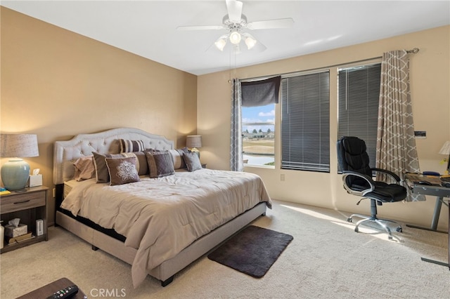 bedroom featuring light colored carpet and ceiling fan