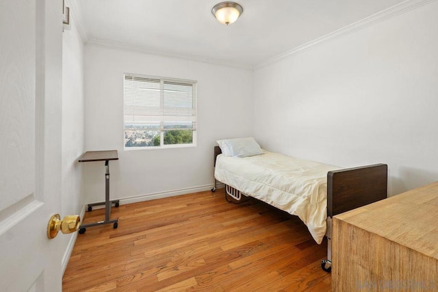 bedroom featuring hardwood / wood-style floors and crown molding