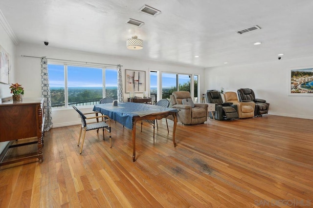 dining room featuring crown molding and light wood-type flooring