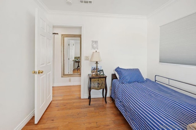 bedroom featuring crown molding and wood-type flooring