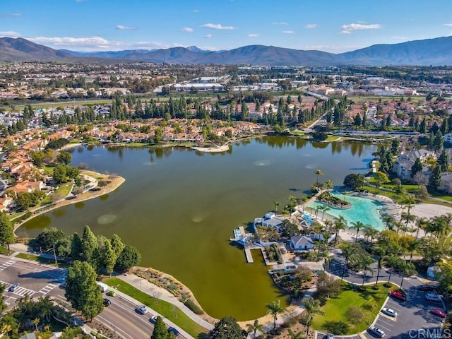 birds eye view of property with a water and mountain view