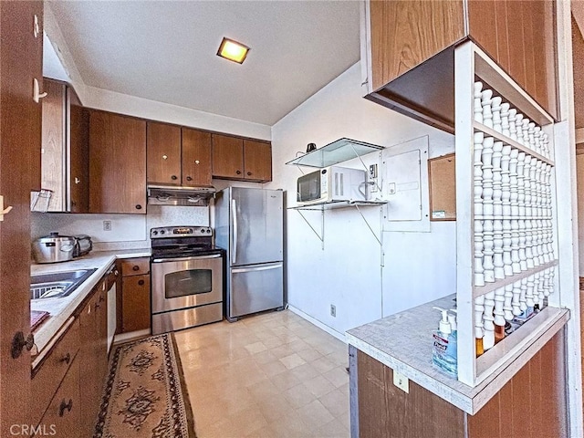 kitchen featuring stainless steel appliances, electric panel, and sink