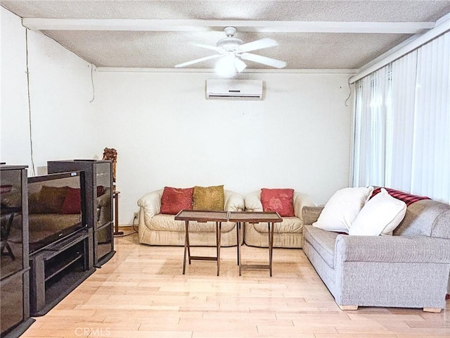 living room featuring ceiling fan, a textured ceiling, light hardwood / wood-style floors, and a wall mounted AC