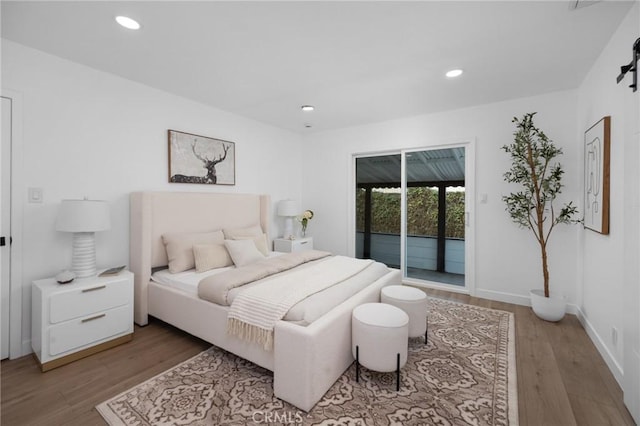 bedroom featuring access to exterior, recessed lighting, light wood-style floors, and baseboards