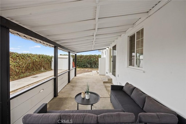 view of patio featuring a shed and outdoor lounge area