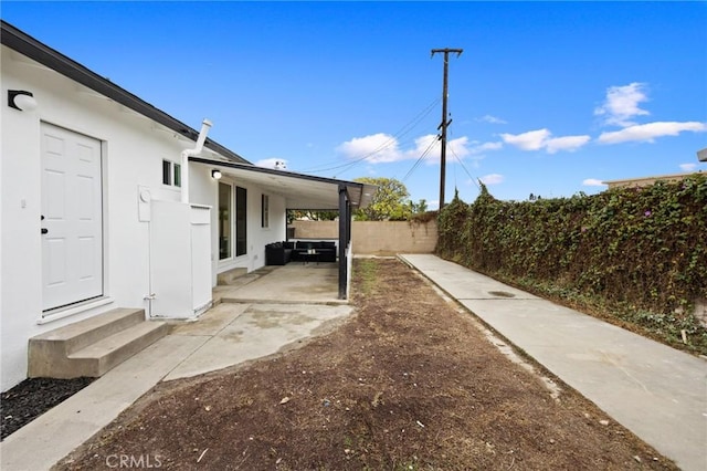 view of yard featuring entry steps, a patio, and fence private yard