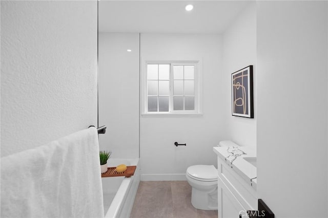 bathroom with toilet, tile patterned floors, baseboards, and vanity