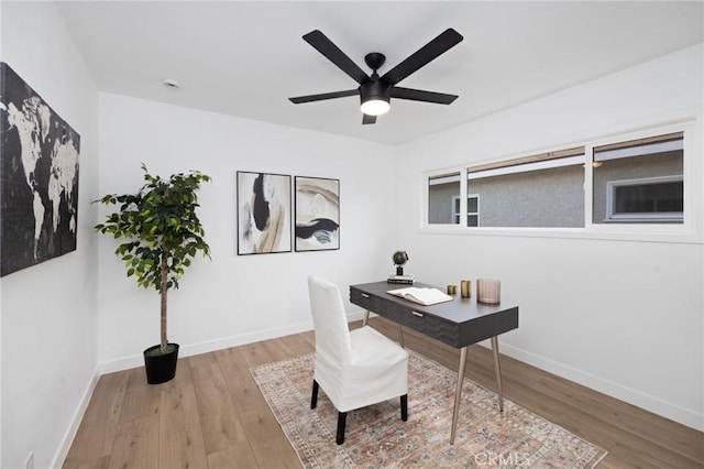 office with ceiling fan, baseboards, and wood finished floors