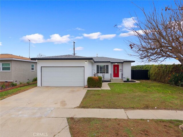 ranch-style house featuring a garage and a front lawn