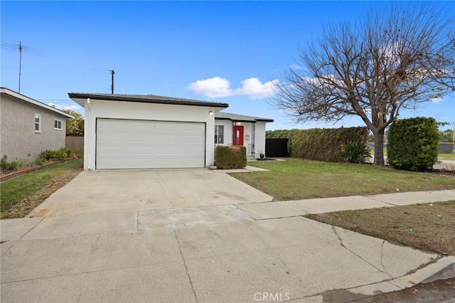 view of front of house with driveway, a front yard, an attached garage, and stucco siding