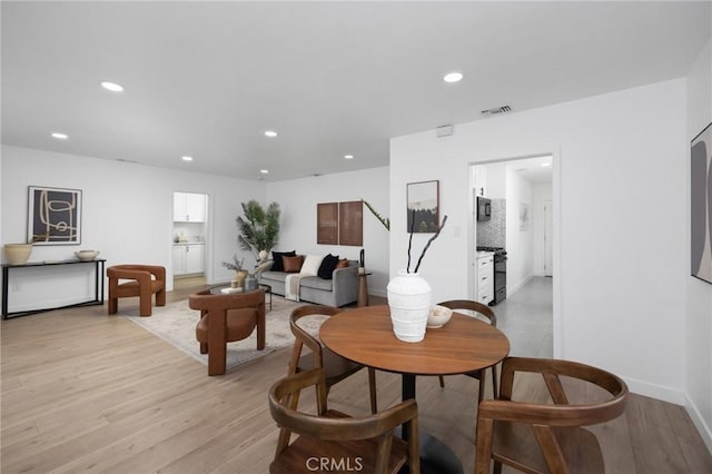 interior space with baseboards, light wood-style flooring, visible vents, and recessed lighting