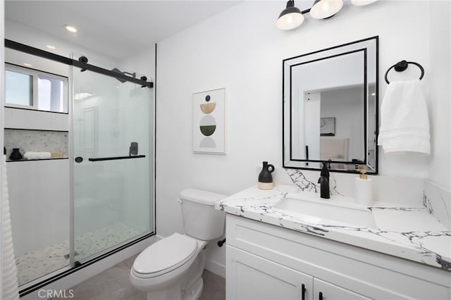 bathroom with toilet, a stall shower, vanity, and recessed lighting