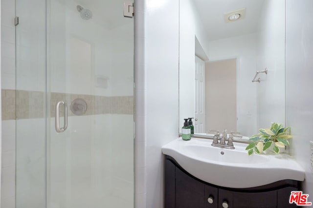 bathroom featuring vanity and walk in shower