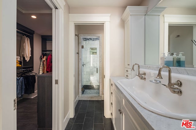 bathroom with vanity, tile patterned floors, and a shower with door