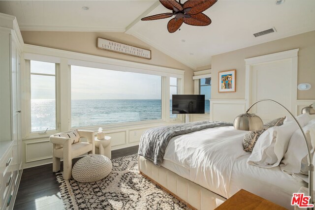 bedroom featuring dark wood-type flooring, ceiling fan, multiple windows, and vaulted ceiling with beams