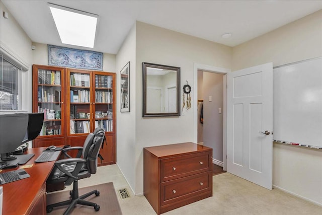 office featuring light carpet and a skylight