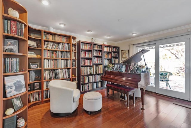 sitting room with hardwood / wood-style flooring and ornamental molding