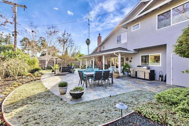 view of patio featuring an outdoor kitchen and a grill