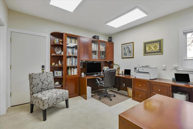 office area featuring light colored carpet and a skylight