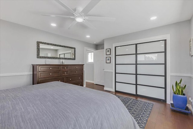 bedroom with ceiling fan, dark hardwood / wood-style floors, and a closet