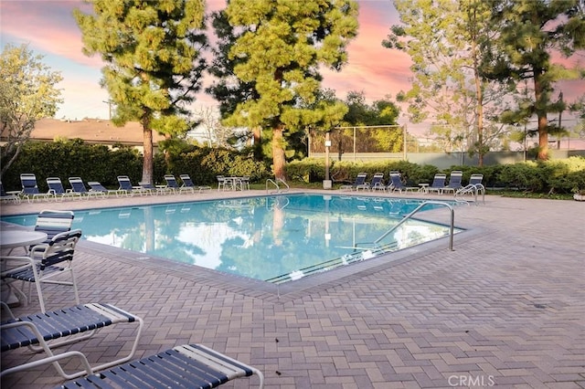 pool featuring a patio area and fence