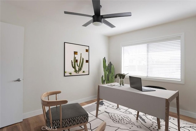 home office with baseboards and light wood-style floors