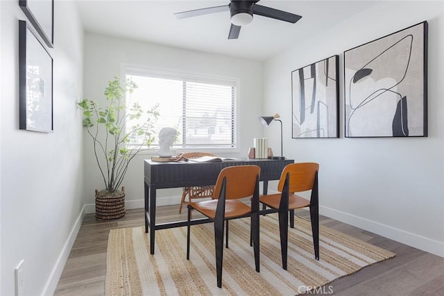 office with baseboards, light wood-style flooring, and ceiling fan