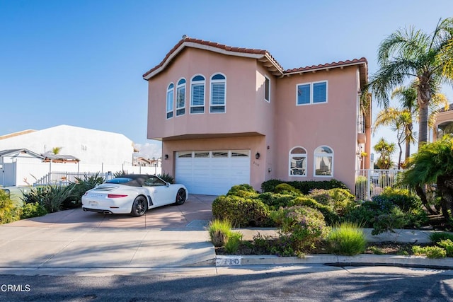 mediterranean / spanish home featuring a garage