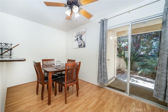 dining space with ceiling fan and light wood-type flooring