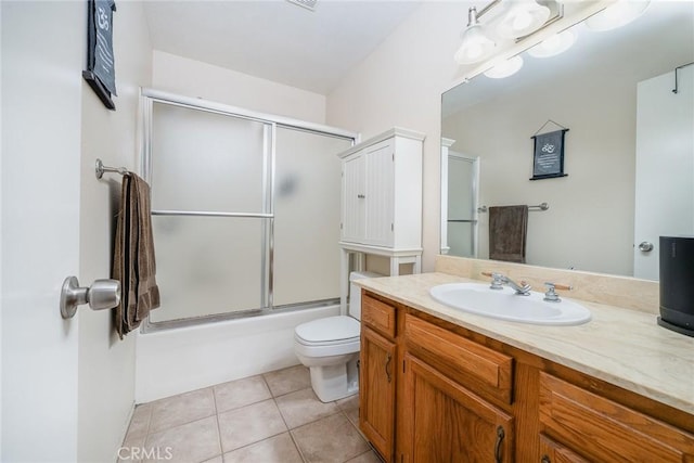 full bathroom with toilet, tile patterned floors, shower / bath combination with glass door, and vanity