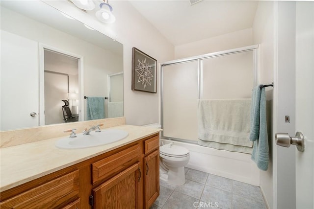 full bathroom with vanity, combined bath / shower with glass door, tile patterned floors, and toilet